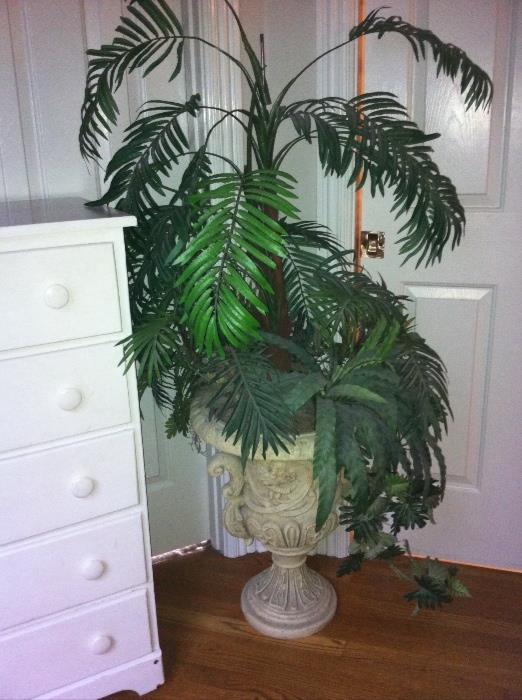 Decorative urn with faux plant.
