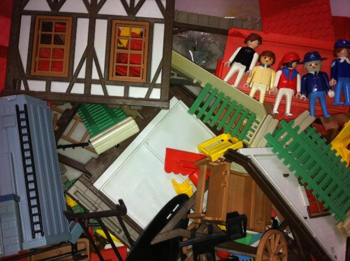 Box of Playmobil people and pieces--parts of several sets.