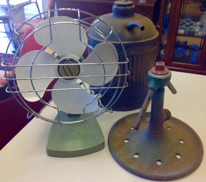 Vintage fan, sprinkler and cans.