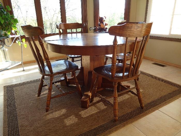 Round oak pedestal table from circa 1900  includes 3 leaves.  Chairs are new. there is a matching buffet, rocker and mirror also available.  See other pictures.