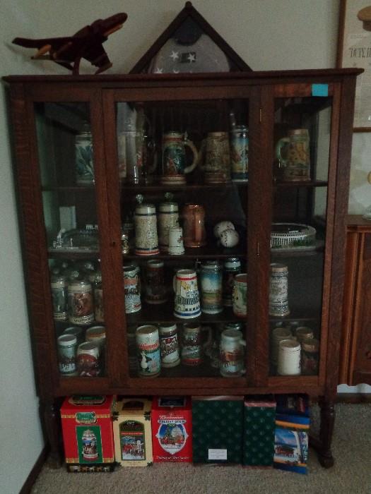 Antique tiger oak china cabinet -- glass on 3 sides -- and all inside.  Great collection of steins -- Anheuser Busch, and others -- many from the Collector series.
