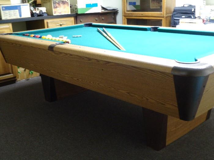 Modern pool table -- slatron top -- like new condition;  Cues, balls, rack and chalk included.  Documentation included.