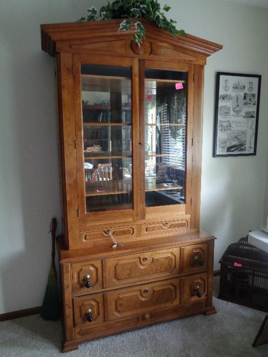 Maple china and storage cabinet from the 1940's.  2 large drawers with original drop pulls; 2 small drawers with built in trays to hold silver .  4 wood shelves; mirror in the back