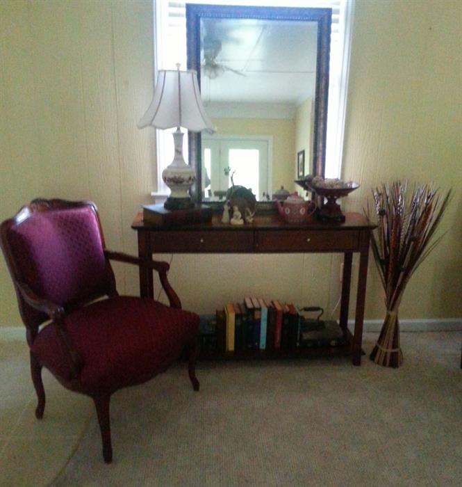 Cherry Console Table with more than 15 Bibles and hymnals.  Vintage lamp with autum leaf design,  large wall mirror.