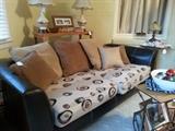Black leather sofa with new seat cushions.  