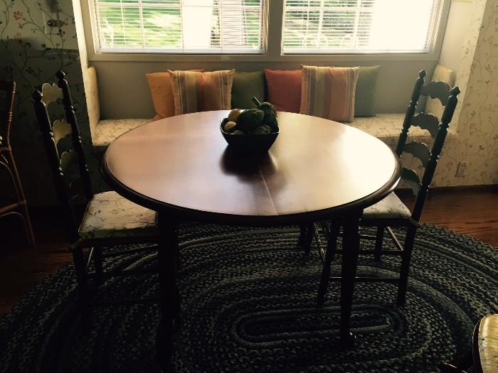 Beautiful table and ladder back chairs on a rag rug