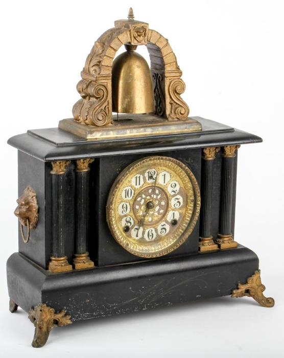 Lot #4, Antique Wm Gilbert Curfew Bell Tower Mantle Clock
 A beautiful vintage key wind, 8-day, Curfew Bell Tower mantle clock made by the Wm. L. Gilbert Clock Company, Winsted, Conn., USA. Comes with pendulum and key, both appear to be original. The clock has a Greek Roman design with black lacquered wood case featuring Ionic columns on either side of the face, lion head with ring in mouth brass medallions on both ends, ornate brass feet, and a beautiful cast brass tower and bell on top. The tin and white enamel dial face features Arabic numerals. The movement is incised with the manufacturer's name as well as the year of production, "1912". Clock strikes on hour and half-hour. Working condition of this clock has not been determined. Measures 18" tall x 16" wide x 6.25" in depth. Tag Words: Intdes, shelf clock