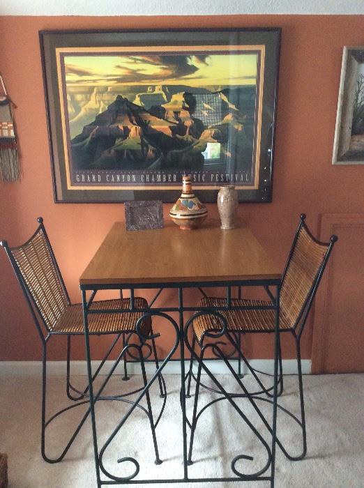 High wrought iron table with two chairs