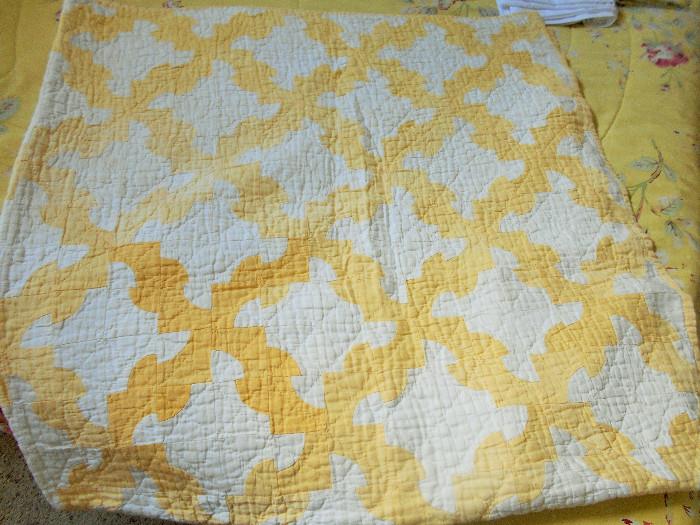 Yellow and white hand stitched quilt