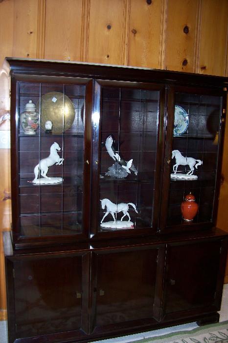 This is a very interesting and beautiful black lacquer glass front cabinet.  Very dramatic in it's appearance - and blends beautifully with modern, retro and oriental furnishings.