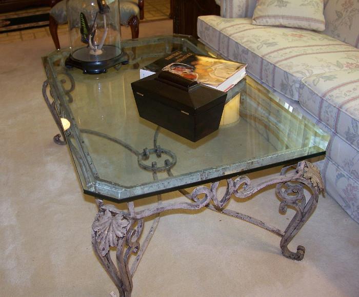 Outstanding and heavy iron and glass coffee table.  Glass is thick and beveled