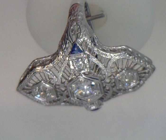 1920-1930 dinner ring, 18K white gold with 5 diamonds, 2 small sapphire side stones. The center diamond is .50 ct and the side diamonds are 20c.