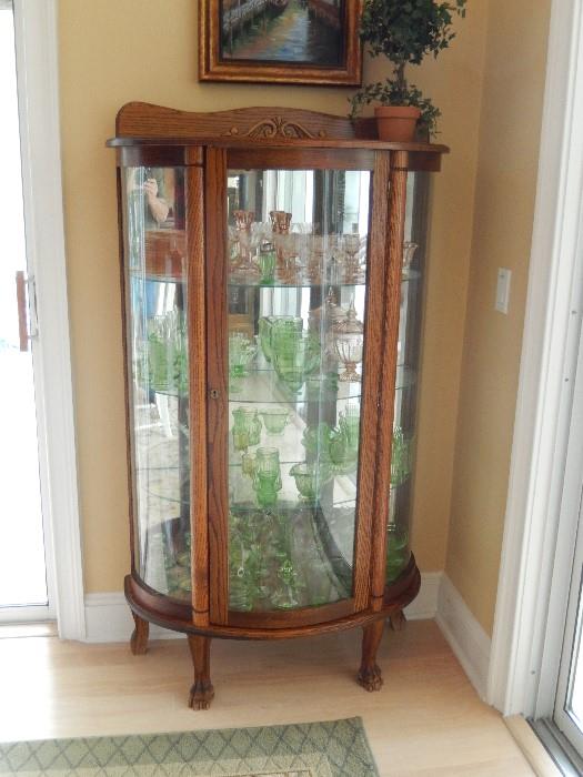 TURN OF 20TH C. CURIO CABINET OAK WITH ALL CURVED GLASS AND KNUCKLE FEET