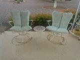 2 white metal swivel rockers.