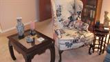 Queen Anne Style Windback Chair with Floral Pattern Upholstery.  Also pictured Hallmark  Mandarin Style End Table with beveled  Glass Insert (End Table is matching to Mandarin Style Coffee Table and Sofa Table pictured elsewhere in  this collection).  Also pictured is a nice set of 3 Nesting Tables.