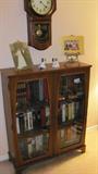 Vintage Bookcase with double wood & glass doors and 3 shelves storage.   Regulator Clock also pictured is not available.