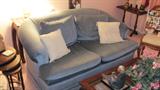 Quality Sawyer  Loveseat with rolled arms and soft blue upholstery.