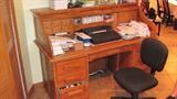 Oak Roll Top Desk with 3 and 3 drawer configuration, and post office style drawers & letter bins.  Also pictured is office chair on casters