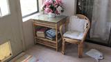 Rattan & Wicker Weave Chair; Rattan & Wicker Weave End / side Table with Bookshelf Storage and glass top; Also pictured is an Accent Vase & Silk Floral Arrangement which are also available