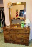Colonial Style Double Dresser with mirror and drawers storage; Dresser is matching to chest of drawers, 3 nightstands, and 2 single headboards which are pictured elsewhere in this collection. Accent table lamp pictured is also available.