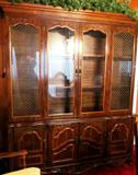 Vintage Lenoir House Vintage lighted China Cabinet with glass and wood doors and drawer storage. This cabinet is matching to a Burlwood Top Table with Leaf, 8 matching Cane Back Chairs with upholstered seats, matching Server with Storage (pictured elsewhere in this collection)