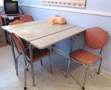 Vintage Retro 1950's Kitchen Furniture: Vintage Dinette Set...Metal Table with Disappearing Sliding leaves, 4 matching metal chairs with pink padded seats and backs (3 of 4 are pictured). This Vintage retro Dinette Set is matching to Vintage Metal and Glass Display Cabinet w/ 3 shelves storage / display...pink finish, and Matching to Metal Roller Cart on wheels w/2 shelves storage...which are pictured elsewhere in this collection.
