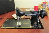 Vintage Singer Featherweight Sewing Machine with original carrying case.