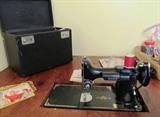 Vintage Singer Featherweight Sewing Machine with original carrying case.