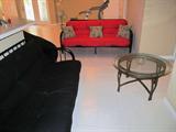 Two Futons with metal frames...queen size mattresses; Also pictured is a glass and metal end table which is matching to other end tables pictured elsewhere in this collection.