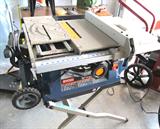 Ryobi 10" Portable Table Saw with Wheeled Stand.  15 AMP motor, built in folding stand with wheels, rip capacity : 30 " to the right, 12" to the left; onboard storage of mitre gauge, rip fence, and push stick; 2 1/2" dust port and dust bag