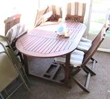 Oval Teak Table with 6 Folding Style Chairs with slatted backs and cushion seats