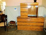 Modern Style Bedroom Set includes Queen Size Headboard, mattress & boxsprings, Matching Double Dresser with Mirror, Matching Writing Desk. As pictured Double Dresser with 6 Drawer storage, honey colored finish with gold trim; Matching Writing Desk with 4 drawer storage; (Matching Queen Size Headboard is pictured elsewhere in this collection). Also pictured is a Brass & Glass Tiered Table with moveable / swingout tiers; Also pictured is a Continental Style Arm Chair with Nicely carved back, cabriolet legs and white upholstered seat.