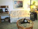 Lovely Queen Size Sleeper Sofa with Creme Colored Tufted Floral upholstery; Also pictured are some of the artworks that are available in this sale. One is a vintage painting of Joan of Arc (likely circa late 1800's to early 1900's). Also shown are two Vintage Duck Lamps...one is missing shade. Also shown is a Round Rattan and Glass Coffee TAble; Also shown is a Vintage Sessions Mantel Clock (there is no key with it so we have been unable to verify that the clock is fully functional). Also shown is a computer office desk with pull out and shelf storage