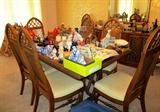 Continental Style Dining Set...includes large dining table with two extra leaves and table pads, 8 matching side chairs with white upholstered seats and woven cane backs with cross hatch style accented tops; matching lighted china cabinet with wood and glass double doors with brass batwing pulls, glass shelves and lower doors storage; matching server