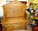 Antique Italian Style Church Bench...heavily carved, with ornate floral and figural carved accents. Bench also has storage. Very striking accent piece