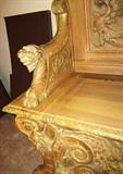 Some of the carvings on an Antique Italian Style Church Bench...heavily carved, with ornate floral and figural carved accents. Bench also has storage. Very striking accent piece