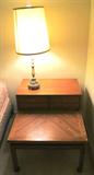 One of two matching nightstands which are part of Beautiful Vintage Bedroom Set by American of Martinsville...which includes Dresser with golden oak finish and 8 large drawers, 4 small center drawers, and a mirror; the two (2) matching two tiered nightstands; Two (2) Single Beds with Single Size Sealy Contessa IV Bed Sets...mattresses, boxsprings, and frames. (Nightstands and Single bed sets are pictured elsewhere in this collection) Accent Table Lamp pictured is also available.