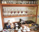 Some of the excellent glasswares that are in this sale...including the colored and clear stemware shown here; Also shown are some of the china cup and saucer sets and hand painted plates that are also available. Other items shown are also available.