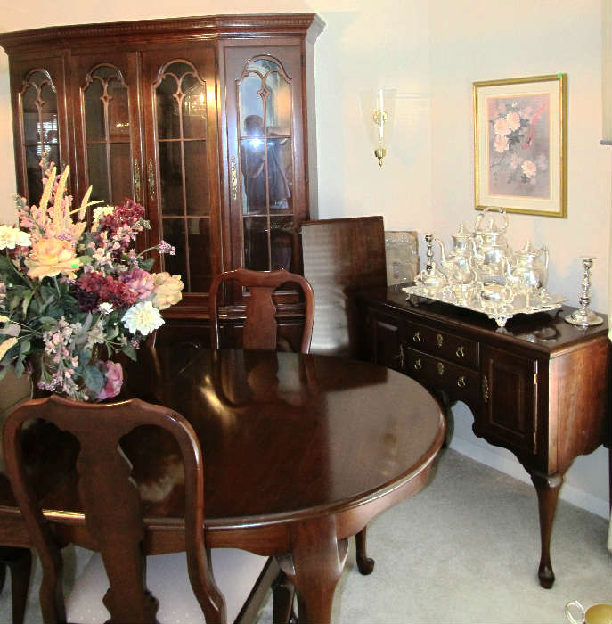 Excellent Dining Room Set  by Pennsylvania House...includes Queen Anne Style  Dining Table with mahogany finish, 2 extra leaves, and with table pads, 6 matching Queen Anne Style Dining Chairs with padded feet (2 Arm Chairs and 4 Side Chairs); Matching Pennsylvania House lighted China Cabinet with 4 glass & wood doors with brass pulls in the upper section, and lots of storage / display/ storage in drawers and door storage; Matching Pennsylvania House Server with Double door and drawers storage; Also shown are some of the excellent collection of silverplate tea service, entertaining and serving items that are in this sale...many appear to be by  Sheridan and also appear to be silver over copper.