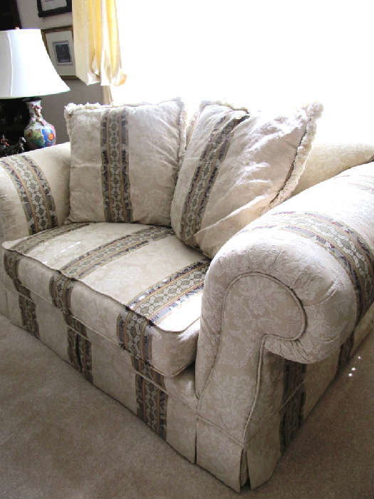Large Overstuffed Style Loveseat with Rolled Arms and  white silk linen upholstery with decorative stripe accents.