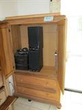 Large Armoire with Double Doors storage area for TV and 2 drawer storage...light finish; Also shown is a Magnavox Surround Sound System which is also available