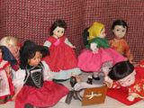 Some of the collection of dolls available in this sale...some vintage...as shown are several dolls of various compositions and nicely dressed in various country attires