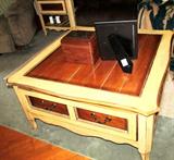Vintage Continental Style Coffee Table with drawer storage and brass pulls. Top has attractive honey colored wood inlays. Coffee Table is matching to a pair of end tables which are pictured elsewhere in this collection.