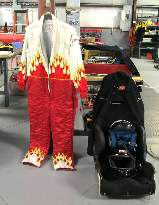 Racing Suit worn by Phil Simms...it was called his "Elvis suit"...excellent condition...beautiful flame colored accents; Also shown is an auto racing Race Car Seat and helmet used by Phil Simms at auto racing events.