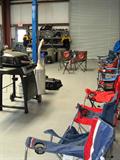 If you need a for an outdoor event...day at the beach...or tailgaiting somewhere...we've got them...and they have a bit of history too...these were used by Phil Simms' racing team. There are even a couple of event chairs from Las Vegas events. Need something even more unique...how about a Quick Fuel Can / Dump Can...also used by the Simms team to get him back into the action after a pit stop; The parts and other items...including some Simms Racing shirts shown hanging on the storage rack, are also available. The BBQ grill is also available