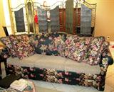 Contemporary style large Sofa with rolled arms and ivy & grape leaf floral pattern upholstered back, sides and front... matching pillows and beige color upholstered seats.  Sofa is matching to loveseat, small bench and ottoman which are pictured elsewhere in this collection.  (Brass Folding Screen is not available)