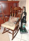 Vintage Colonial Style High backed  Oversize Rocker with splat back spindles and nicely stenciled accents. Also shown is an upright Dirt Devil vacuum cleaner which is also available.