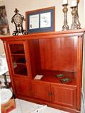 Entertainment Center with wood and glass doors & shelves storage, large area for TV,  and rich mahogany finish.  Also shown are a trio of matching Candle Holders, Framed Signed Maryland proclamation and signed artwork print of two beautiful songbirds... and a whimsical timepiece which are also available.
