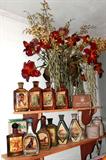 Collection of Vintage Beam Whiskey bottles...and a vintage Medical Supply Co. First Aid Kit...must be the Beam Whiskey was medicinal... Also shown are two Vintage Stoneware Crocks (likely used for shipping Cheese or Butter) marked Kaukauna Klub, Kaukauna Dairy Co. Wisconsin.  Floral decorations are also available.