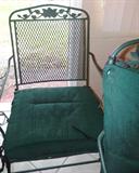 One of 4  Matching Vintage Wrought Iron Porch/ Patio Chairs part of a   Vintage Wrought Iron Porch / Patio  Set...includes Oval Shaped Wrought Iron Table with green finish,  4 Matching  Wrought Iron  Chairs...that rock.  Chairs  have nicely scrolled metal vine and leaf accents on their backs and also have green cushions.